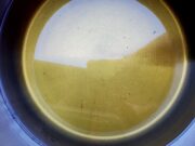 A saucepan containing fresh made tea concentrate with tea leaves removed.