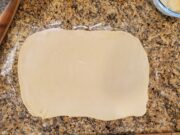Dough rolled into a rectangle on floured surface
