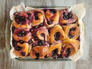 9×13 inch pan containing 12 baked Blueberry cinnamon rolls.
