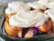 Cloe up shot of iced blueberry cinnamon rolls in a rectangle pan