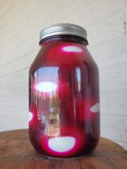 Quart jar of eggs in beet juice.