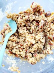 A bowl full of crunch pecan topping that been mixed together.