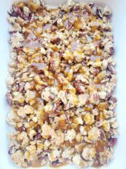 Pecan crunch and caramel toppings in a rectangle pan.